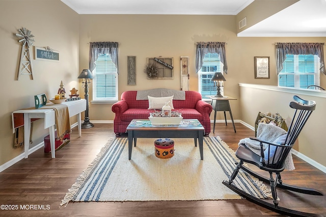 interior space featuring ornamental molding, wood finished floors, and visible vents