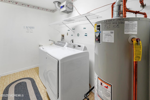 laundry room featuring laundry area, water heater, baseboards, and separate washer and dryer