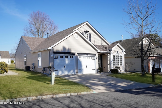 view of front facade with a garage, a front yard, driveway, and central AC unit