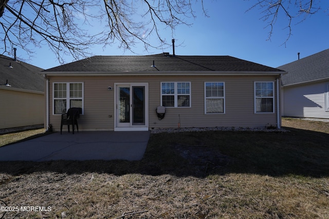 rear view of house featuring a lawn and a patio area