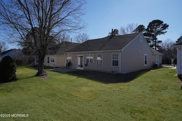 rear view of house featuring a yard, french doors, a chimney, and a patio area