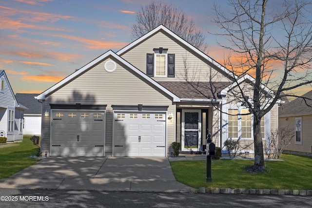 view of front of property with driveway, a shingled roof, and a yard