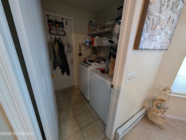 laundry room with laundry area, a baseboard radiator, light tile patterned flooring, and washer and dryer