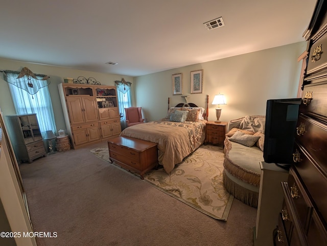 bedroom with visible vents and light colored carpet