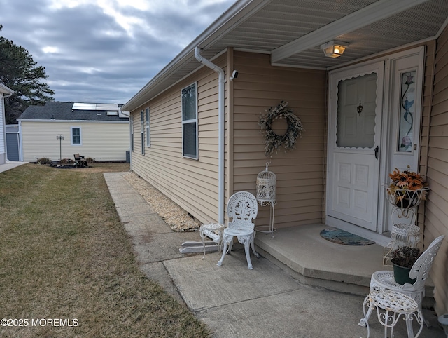 property entrance with a lawn