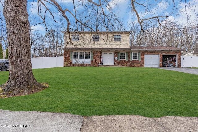 view of front of home featuring brick siding, an attached garage, fence, driveway, and a front lawn