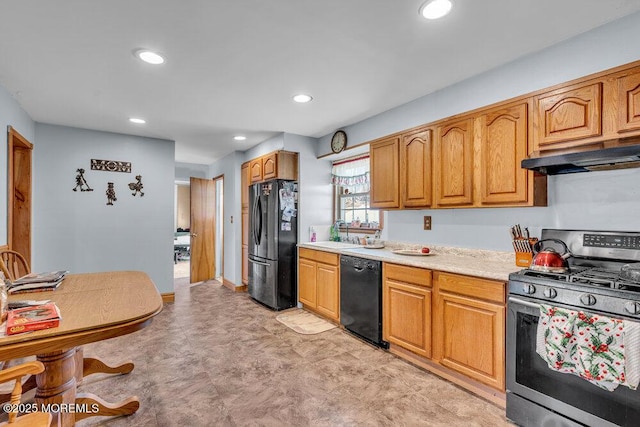 kitchen with brown cabinets, recessed lighting, light countertops, under cabinet range hood, and black appliances