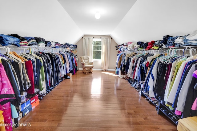 walk in closet featuring lofted ceiling and wood finished floors