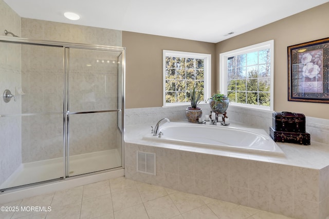 bathroom featuring a stall shower, tile patterned flooring, visible vents, and a garden tub