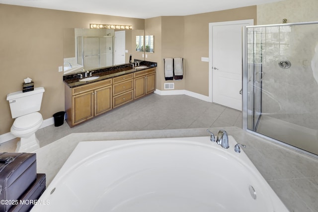 bathroom with visible vents, a sink, a shower stall, and double vanity