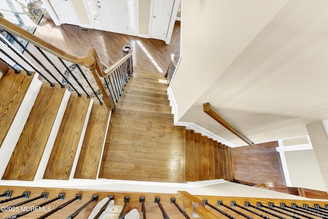 stairway with visible vents and wood finished floors