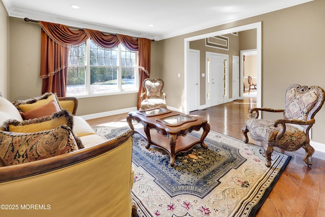 sitting room with ornamental molding, recessed lighting, baseboards, and wood finished floors