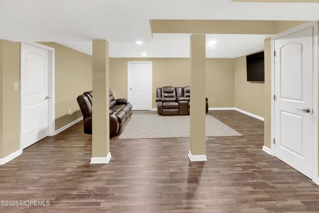 exercise area with baseboards, wood finished floors, and recessed lighting