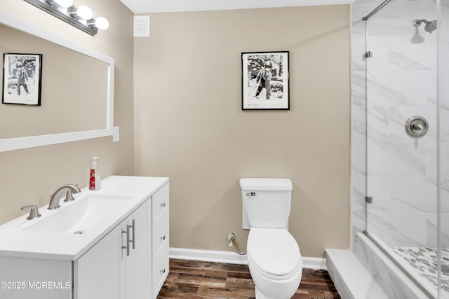 full bathroom featuring toilet, baseboards, wood finished floors, and tiled shower