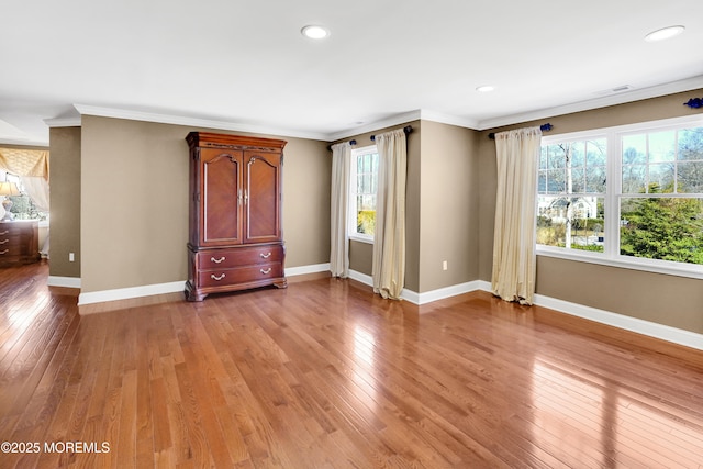 unfurnished bedroom with crown molding, recessed lighting, visible vents, light wood-style flooring, and baseboards