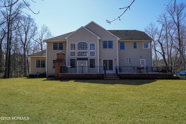 back of house featuring a yard and a deck