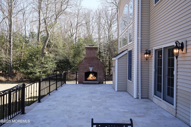 view of patio / terrace featuring an outdoor brick fireplace