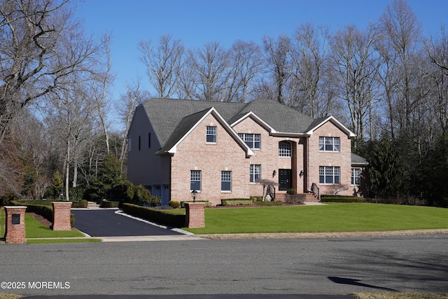 view of front facade featuring a front lawn and brick siding