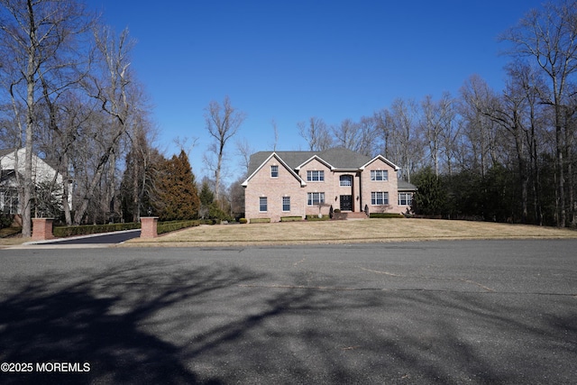 colonial home with a front lawn