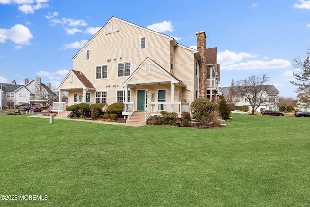 view of front facade featuring a porch, a front lawn, and a chimney