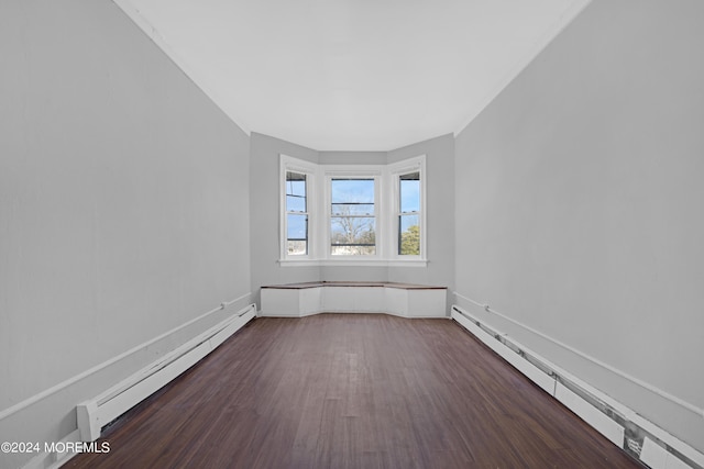 unfurnished room featuring a baseboard radiator and dark wood finished floors