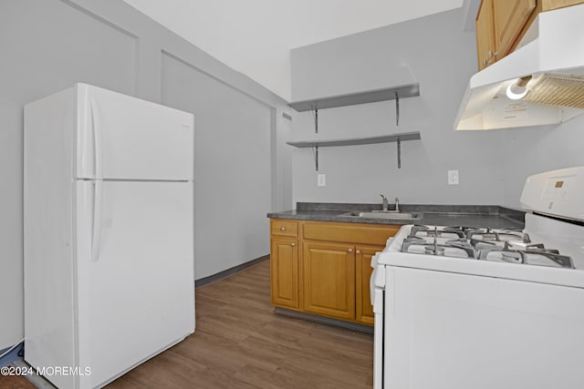 kitchen with white appliances, wood finished floors, under cabinet range hood, open shelves, and a sink