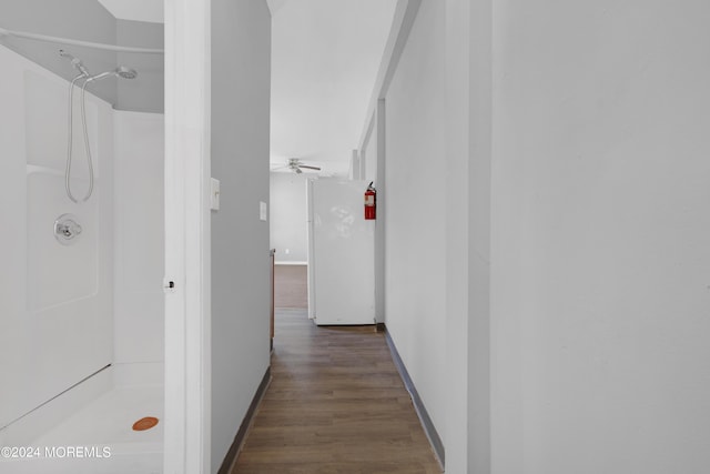 hallway featuring dark wood-style floors and baseboards