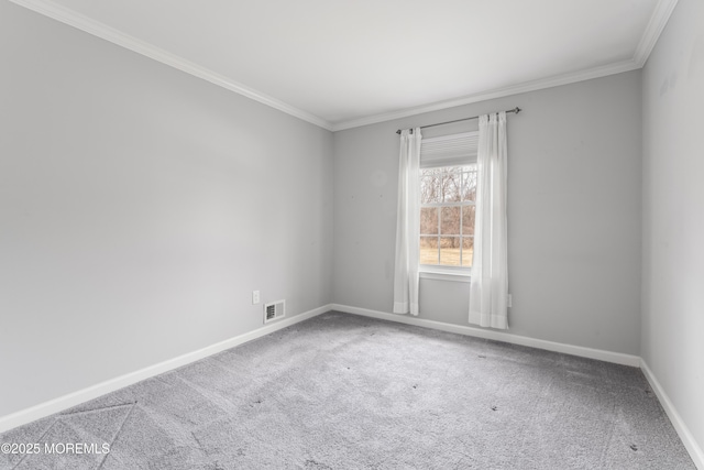 carpeted empty room with baseboards, visible vents, and crown molding