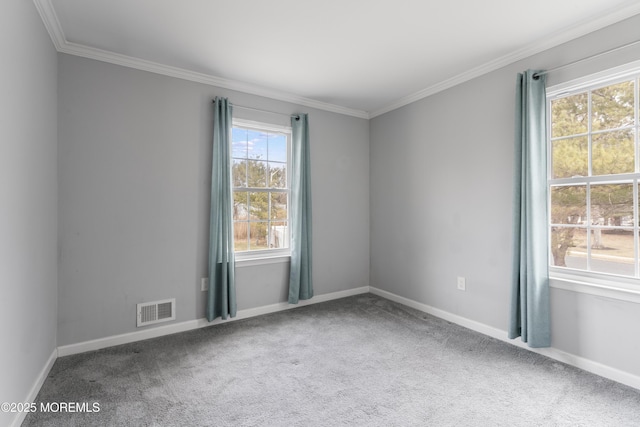 carpeted spare room featuring ornamental molding, visible vents, and baseboards