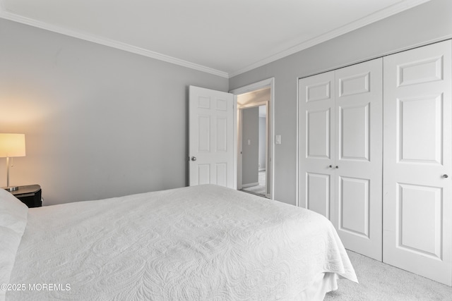 carpeted bedroom featuring a closet and crown molding