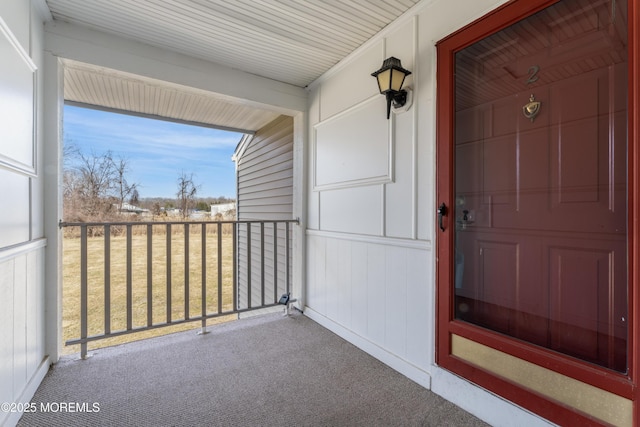 property entrance with covered porch and a yard