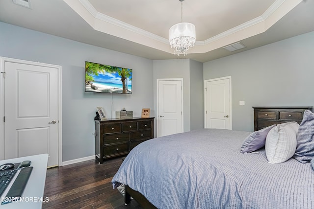 bedroom featuring dark wood-type flooring, a raised ceiling, visible vents, and ornamental molding