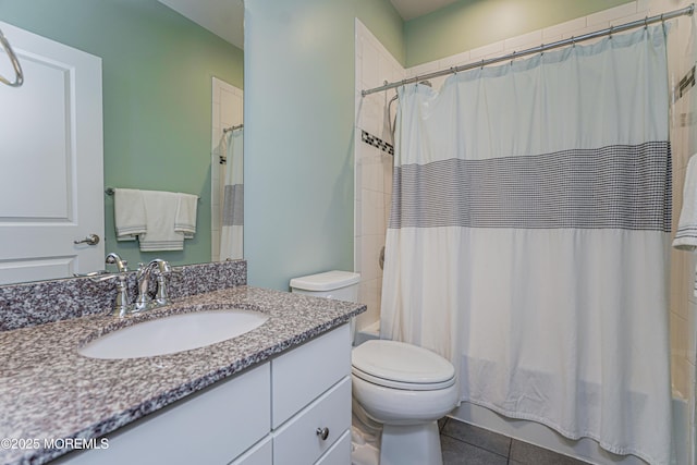 bathroom featuring shower / bath combo, vanity, toilet, and tile patterned floors