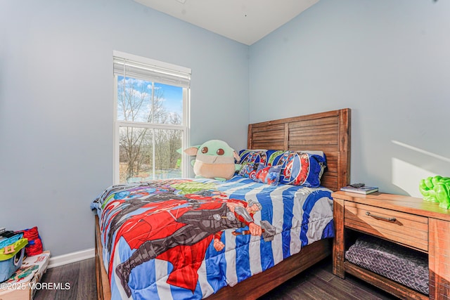 bedroom featuring baseboards and wood finished floors