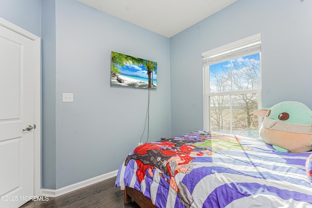 bedroom with baseboards and wood finished floors