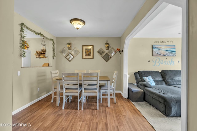 dining area featuring baseboards and wood finished floors