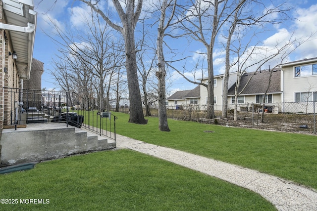 view of yard featuring a residential view and fence