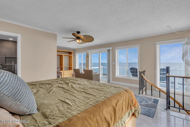 bedroom featuring a textured ceiling, access to outside, multiple windows, and baseboards