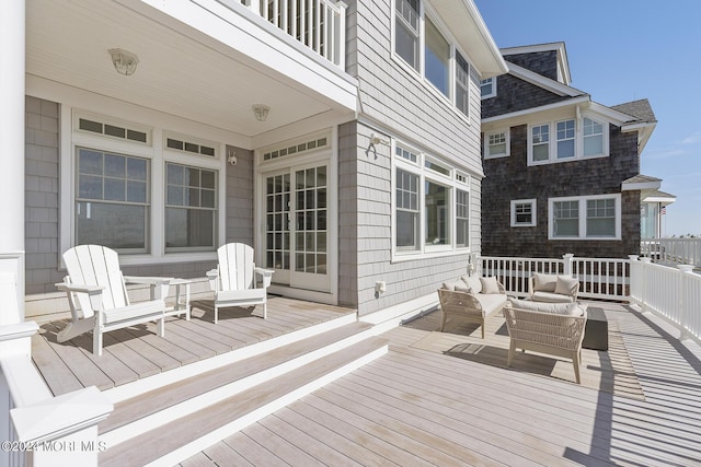 wooden deck with an outdoor living space