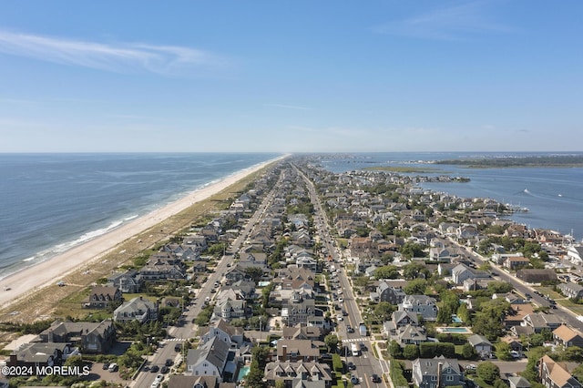 birds eye view of property with a water view, a residential view, and a beach view