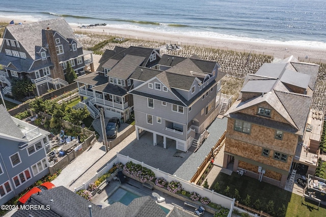 aerial view with a water view and a view of the beach