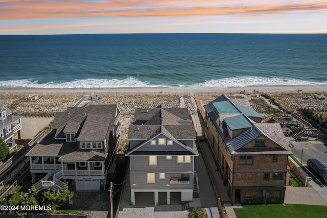 aerial view with a water view and a beach view