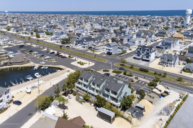 bird's eye view with a residential view and a water view