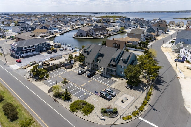 drone / aerial view featuring a residential view and a water view