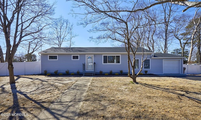 single story home featuring entry steps, fence, and an attached garage