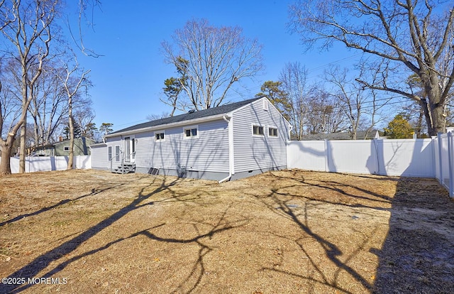 view of side of property with entry steps, crawl space, and a fenced backyard