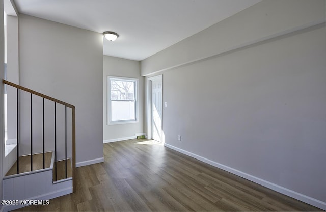 interior space featuring dark wood-type flooring and baseboards