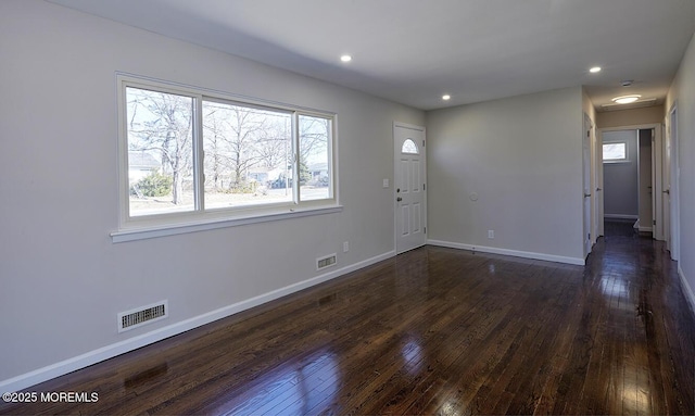 foyer featuring baseboards, visible vents, and dark wood-style flooring