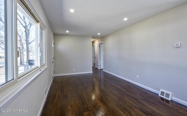 spare room featuring baseboards, visible vents, wood finished floors, and recessed lighting