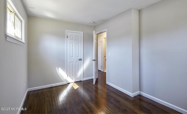 unfurnished bedroom with baseboards and hardwood / wood-style floors